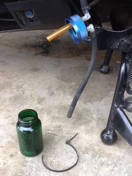 Catch Can....one empty pill bottle...two 1/4" holes...two plastic elbows...a bit of JB Weld....one zip tie